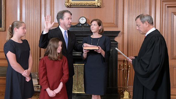 Chief Justice John Roberts, right, administers the Constitutional Oath to Judge Brett Kavanaugh in the Justices' Conference Room of the Supreme Court Building.