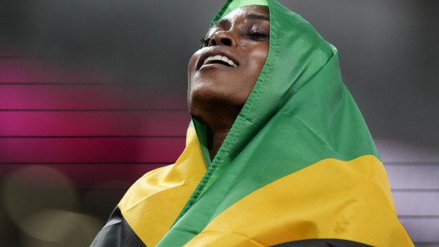 Elaine Thompson-Herah, of Jamaica, celebrates gold. 