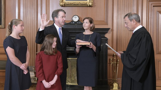 Chief Justice John Roberts, right, administers the Constitutional Oath to Judge Brett Kavanaugh in the Justices' Conference Room of the Supreme Court Building.