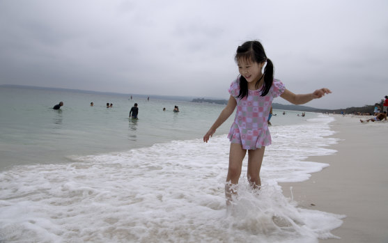 Yuhan Gao, from Shanghai, enjoys the waters of Hyams Beach on Monday.