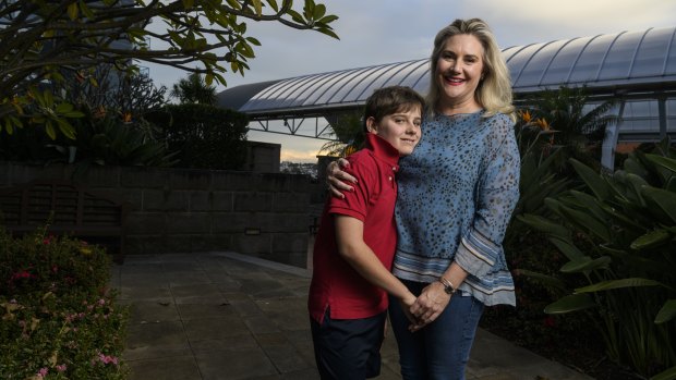 Senator Hollie Hughes, with son Fred who has autism, said the independent assessment trialled uses a “tick-a-box algorithm”.