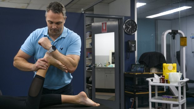 Physiotherapist Tom Sheehan with a patient at Northside Sports Physiotherapy. 