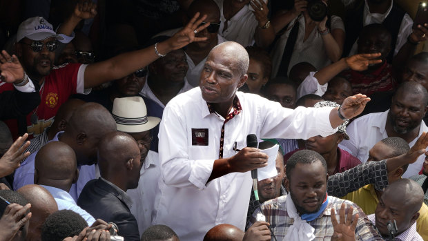 Defeated Congo opposition candidate Martin Fayulu greets supporters as he arrives at a rally in Kinshasha, Congo, on Friday. He is challenging the election result.