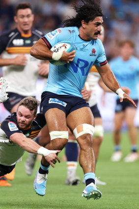 Charlie Gamble is tackled in the Waratahs’ Super Rugby opener on Friday.