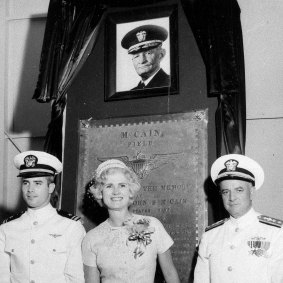 In this July 14, 1961, file photo, US Navy Lieutenant Commander John S McCain III, left, and his parents, Rear Admiral John S McCain Jr, right, and Roberta Wright McCain stand in front of a plaque with an image of his grandfather, Admiral John S McCain, at the Naval Air Station Meridian McCain Field in Mississippi. 