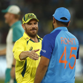 Aaron Finch shakes hands with Rohit Sharma after game three of Australia’s Twenty20 series against India.
