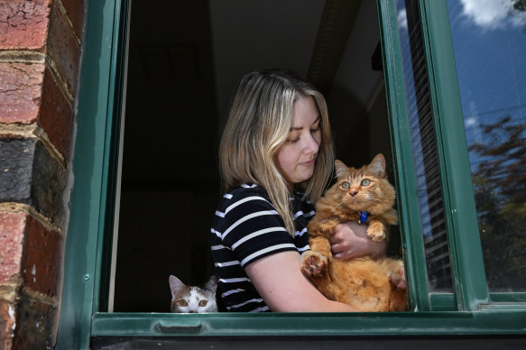 Sarah Lowres with Gidget, the ginger day-time outdoor cat, and calico cat Ducky, who lives inside permanently.