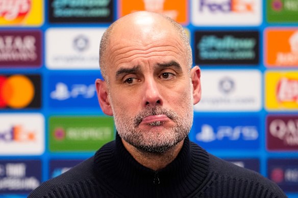 Man City coach Pep Guardiola looks despondent after the loss.