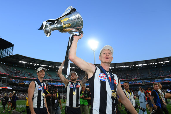 Will Hoskin-Elliott holds the cup aloft.