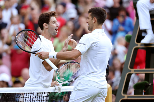 Novak Djokovic shakes hands with Jordan Thompson after the match.