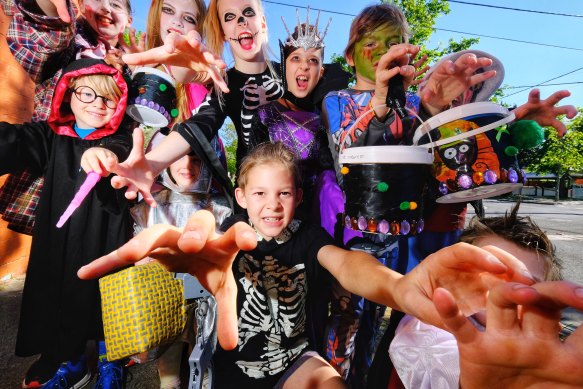 Children pose for a photo before going on a trick or treat walk in Moonee Ponds on Sunday.
