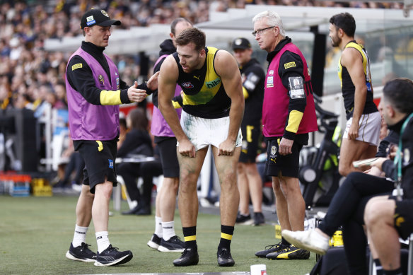 Noah Balta talking to doctors after hurting his hamstring.