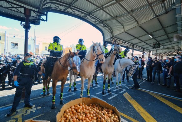 Stunned shoppers watched as police clashed with protesters at the market.