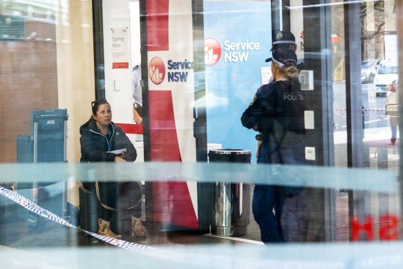 Police at the Haymarket Service NSW branch where an employee was stabbed on Friday.