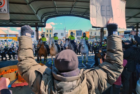 Anti-lockdown protesters confront police at the Queen Victoria market, September 13, 2020.