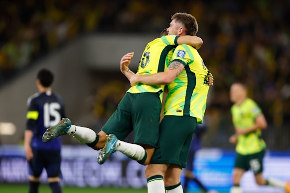 Cameron Burgess of the Socceroos and Paul Izzo of the Socceroos celebrate the win against Japan