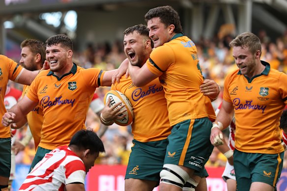 Wallabies and Queensland Reds player Massimo De Lutiis celebrates scoring a try on debut.