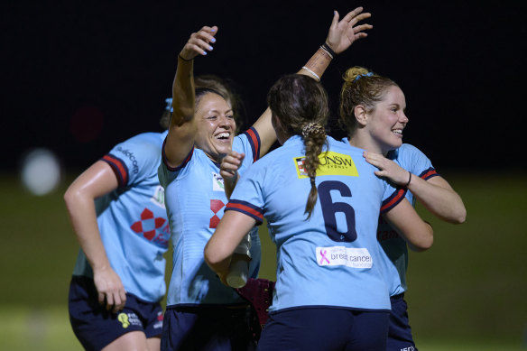 Iliseva Batibasaga raises her arms in triumph after the Waratahs progressed to the Super W final.