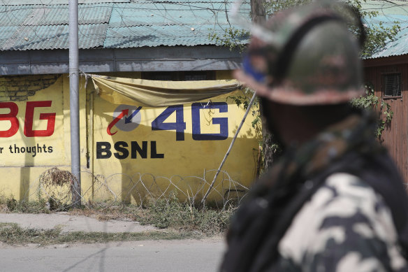 An Indian paramilitary soldier keeps guard outside the main telephone exchange building in Srinagar, Indian controlled Kashmir during the 18-month ban on high speed internet services.