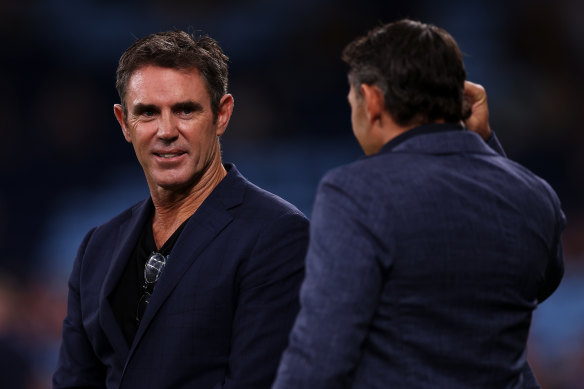 Brad Fittler and Billy Slater chat with each other during a game in March.