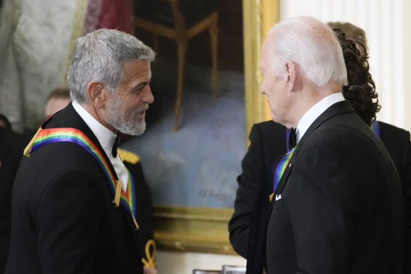 President Joe Biden shakes hands with George Clooney during the Kennedy Centre honourees reception at the White House in Washington, December 2022.