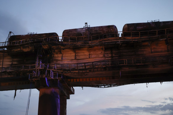 A view of burnt tanks on a damaged part of the bridge connecting the Russian mainland and the Crimean peninsula over the Kerch Strait.