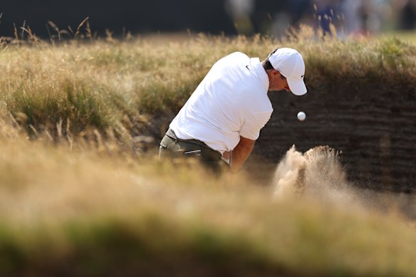 Rory McIlroy plays in the dugout in the third round of the British Open.
