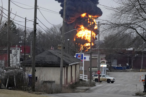 A black plume and fireball rise over East Palestine as a result of a controlled detonation of part of the derailed train.