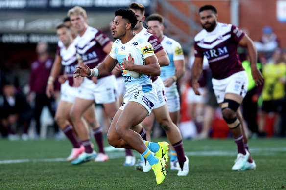 Alofiana Khan-Pereira of the Titans runs the ball against Manly.