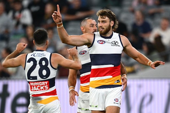Riley Thilthorpe is congratulated by teammates after kicking a goal.