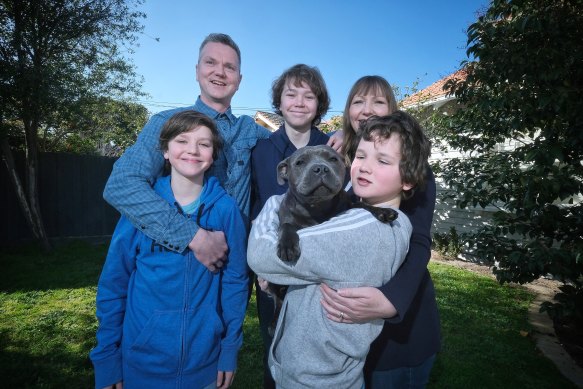 Alison and Jared with their children Jacob (14), Daniel (13), Jude (10), and Marley (dog) outside their home in Hampton.