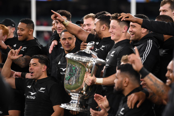 All Blacks players celebrate with the Bledisloe Cup.