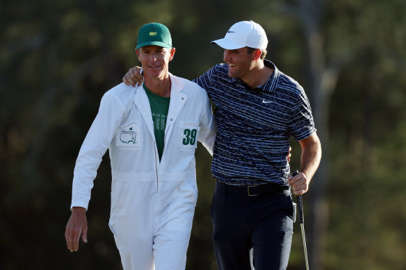 Scottie Scheffler celebrates with caddie Ted Scott on the 18th green at Augusta.