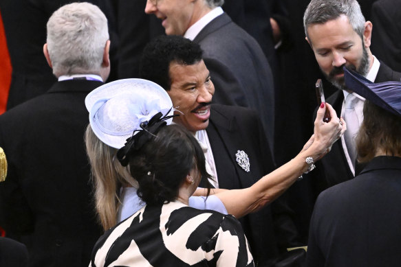Lionel Richie takes selfies with guests ahead of the Coronation of King Charles III and Queen Camilla.