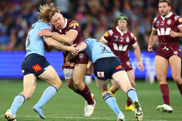 Cam Murray (in there somewhere) makes a tackle. 