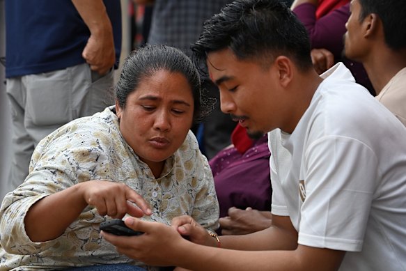 Family members gather at a Nepalese hospital to search for their loved ones.