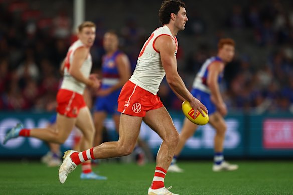 Tom McCartin of the Swans runs with the ball.