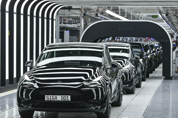 Model Y electric vehicles stand on a conveyor belt at the opening of the Tesla factory at the Gigafactory Berlin-Brandenburg in Grünheide, Germany, in March. 