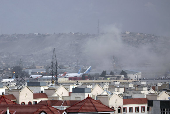 Smoke rises from an explosion outside Kabul airport on Thursday.