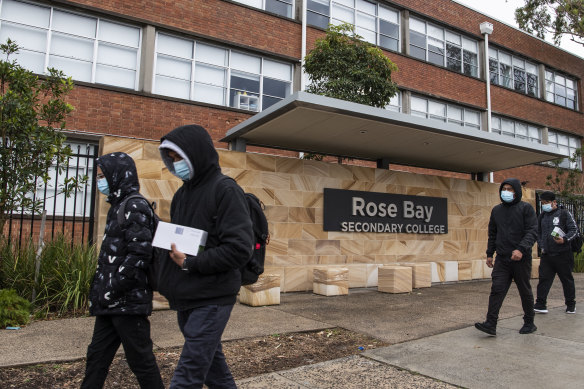 Cleaners arrive at Rose Bay Secondary College in Dover Heights on Tuesday after a student tested positive to COVID-19.