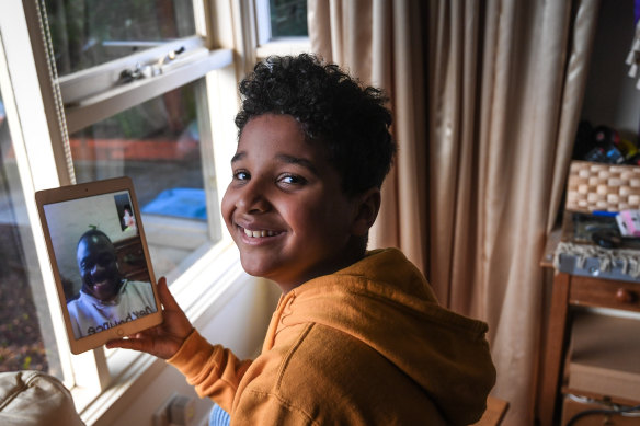 Ndahmowa, 9, talks to relatives on FaceTime.