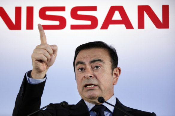 Then Nissan president and CEO Carlos Ghosn speak during a press conference in Yokohama, near Tokyo, in 2012.  