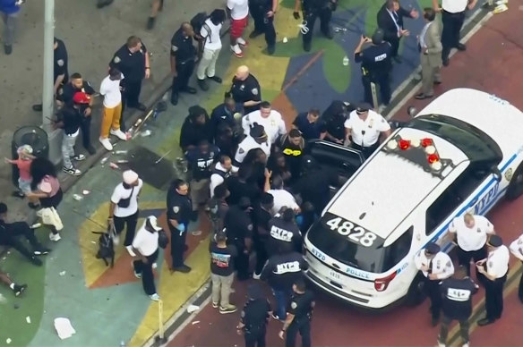 Internet influencer Kai Cenat (centre) is helped into a New York Police vehicle near Union Square on Friday.