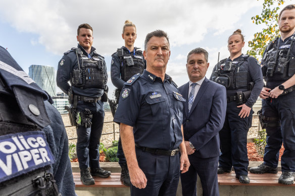 Acting Commissioner Bob Hill (centre) and Detective Inspector Michael Daly and Viper officers.