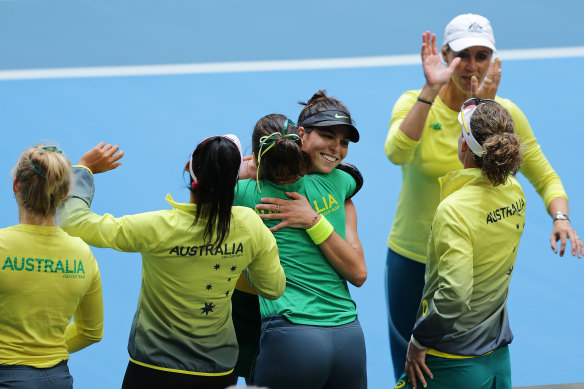Tomljanovic is congratulated by her teammates after winning her singles match to keep the team’s Fed Cup hopes alive.