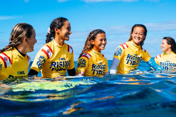 Locals and pros share the waves at Teahupo’o as part of the WSL’s Rising Tides program in 2022.