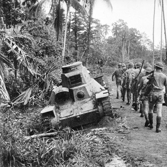 A group of Australian soldiers inspecting two disabled Type 95 Ha-Go Japanese light tanks. Late August, 1942.