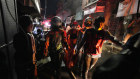 Indonesian rescue team carry a victim of fire at a neighbourhood in Jakarta, Indonesia.