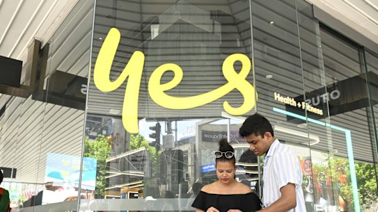 Ranish Kromodoyo and Anya Absalom struggle to make a call outside an Optus store.
