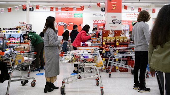 Shoppers lining up at Broadway Coles last month.